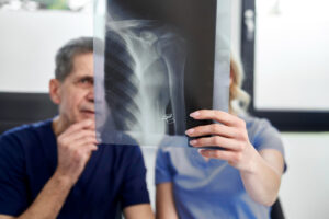 Doctor reviewing an X-ray during recovery after minimally invasive spine surgery