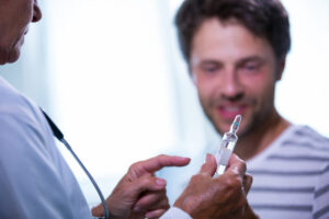 Doctor diagnosing a male patient with hypogonadism and evaluating if is testosterone replacement therapy covered by insurance