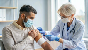 Nurse injecting testosterone into a man, raising the question is testosterone replacement therapy covered by insurance