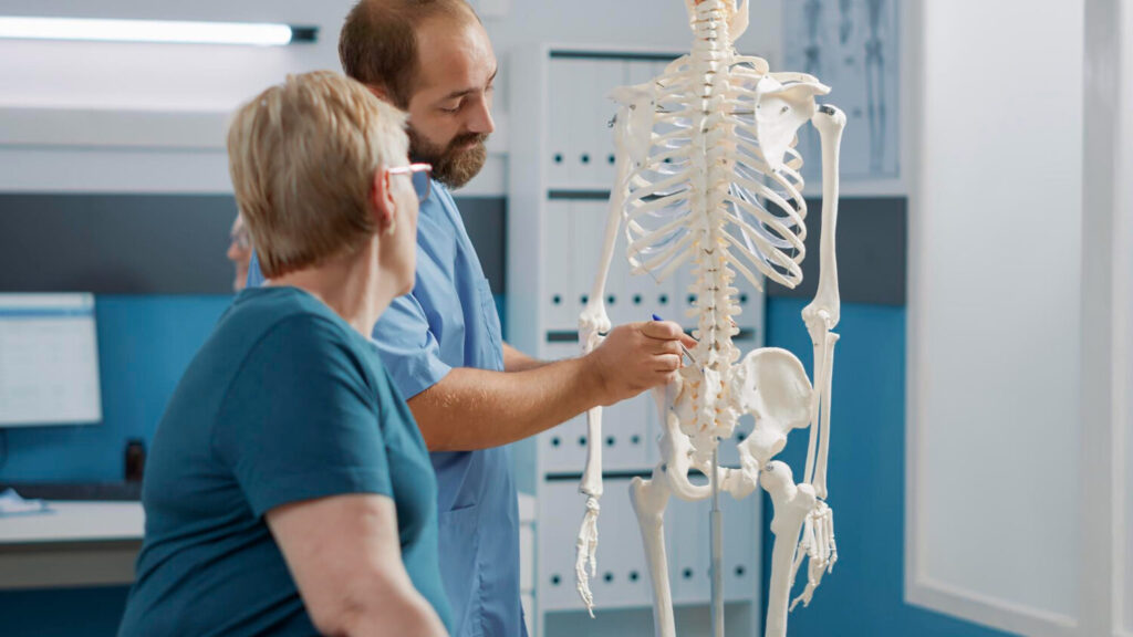 Doctor explaining who is a candidate for minimally invasive spine surgery during a consultation at IntegraMed.