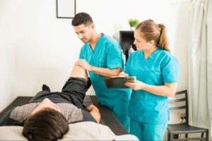 Healthcare professionals conducting a lower extremity assessment on a patient during sports medicine, orthopedic, or injury prevention evaluation.