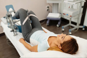Patient undergoing a clinical orthopedic or sciatica evaluation with specialized lower body positioning equipment for diagnostic assessment and treatment planning.