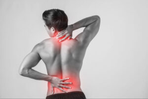 Man holding his neck and lower back with highlighted pain areas, illustrating cervical and lumbar spine discomfort or musculoskeletal injury.