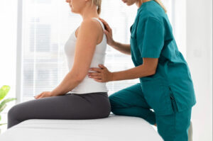 Medical professional evaluating a patient’s posture and spinal alignment during a clinical back or sciatica assessment.