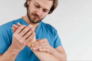 Physical therapist examining and guiding hand and wrist movements during rehabilitation and recovery after carpal tunnel release surgery.