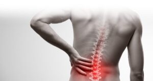 Person experiencing chronic lower back pain with highlighted lumbar spine symptoms before lumbar fusion surgery