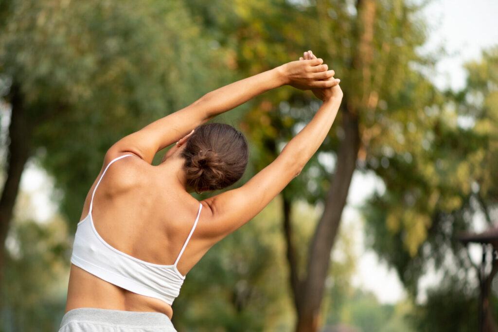Patient performing stretching exercises as part of lumbar fusion surgery recovery and rehabilitation