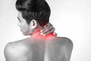 Person experiencing severe neck pain during recovery after cervical fusion surgery, highlighting symptoms that may require medical attention