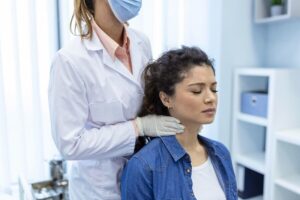 Patient receiving a pre-operative cervical spine assessment before cervical fusion surgery