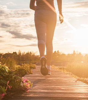 A person walks at sunset after total joint replacement in Boynton Beach.