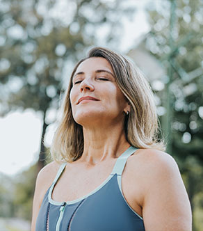 A woman considering total joint arthroplasty in Boynton Beach meditates.