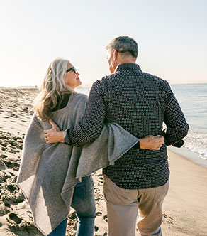 A couple shares a walk on the beach after total joint arthroplasty in Boynton Beach.