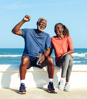 A man celebrates with his partner after total joint arthroplasty in Boynton Beach.